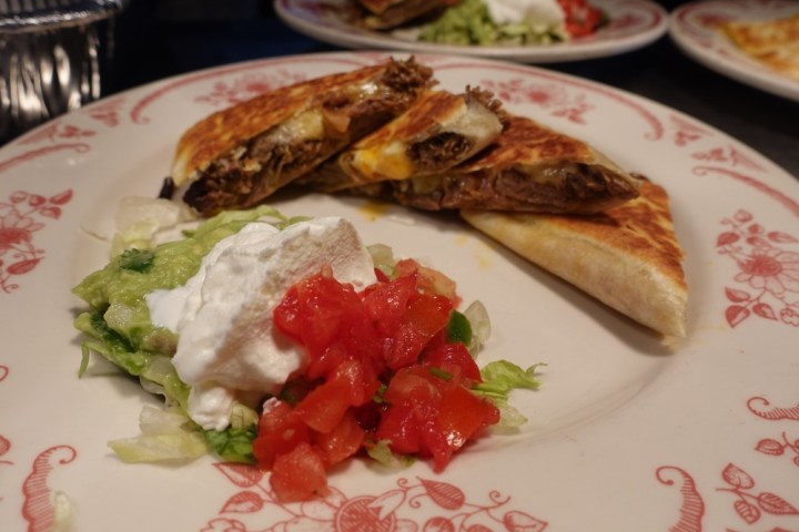 a plate of food with a slice of pizza