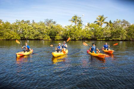a group of people in a small boat in a body of water