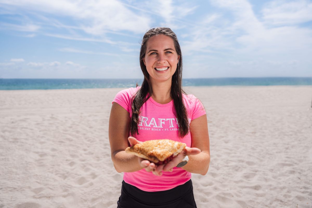 a woman standing in front of a body of water