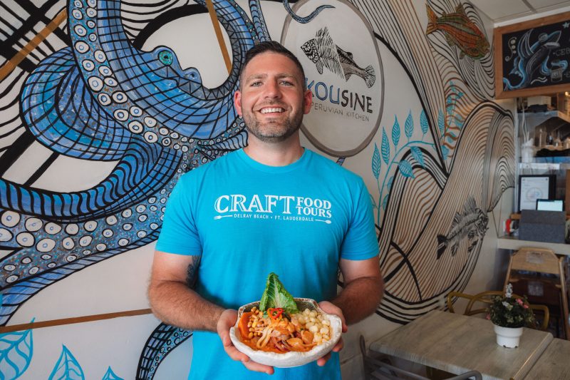 a person holding a plate of food