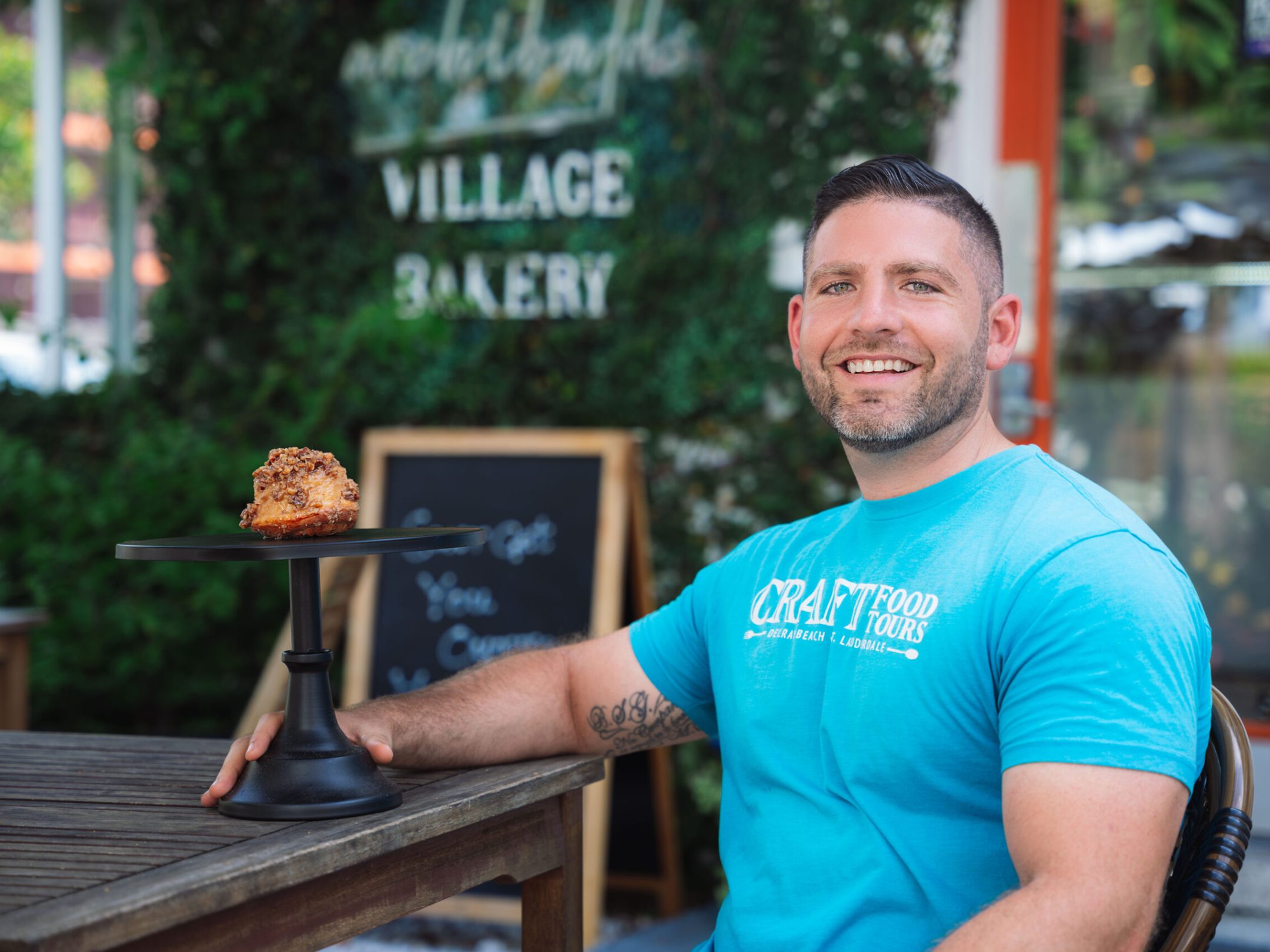 a man standing in front of a blue bench