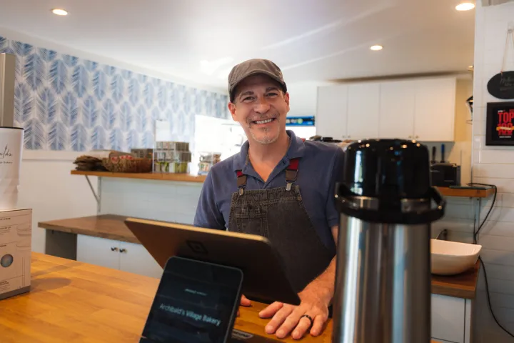 a person sitting at a table using a laptop