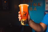 a hand holding a cup