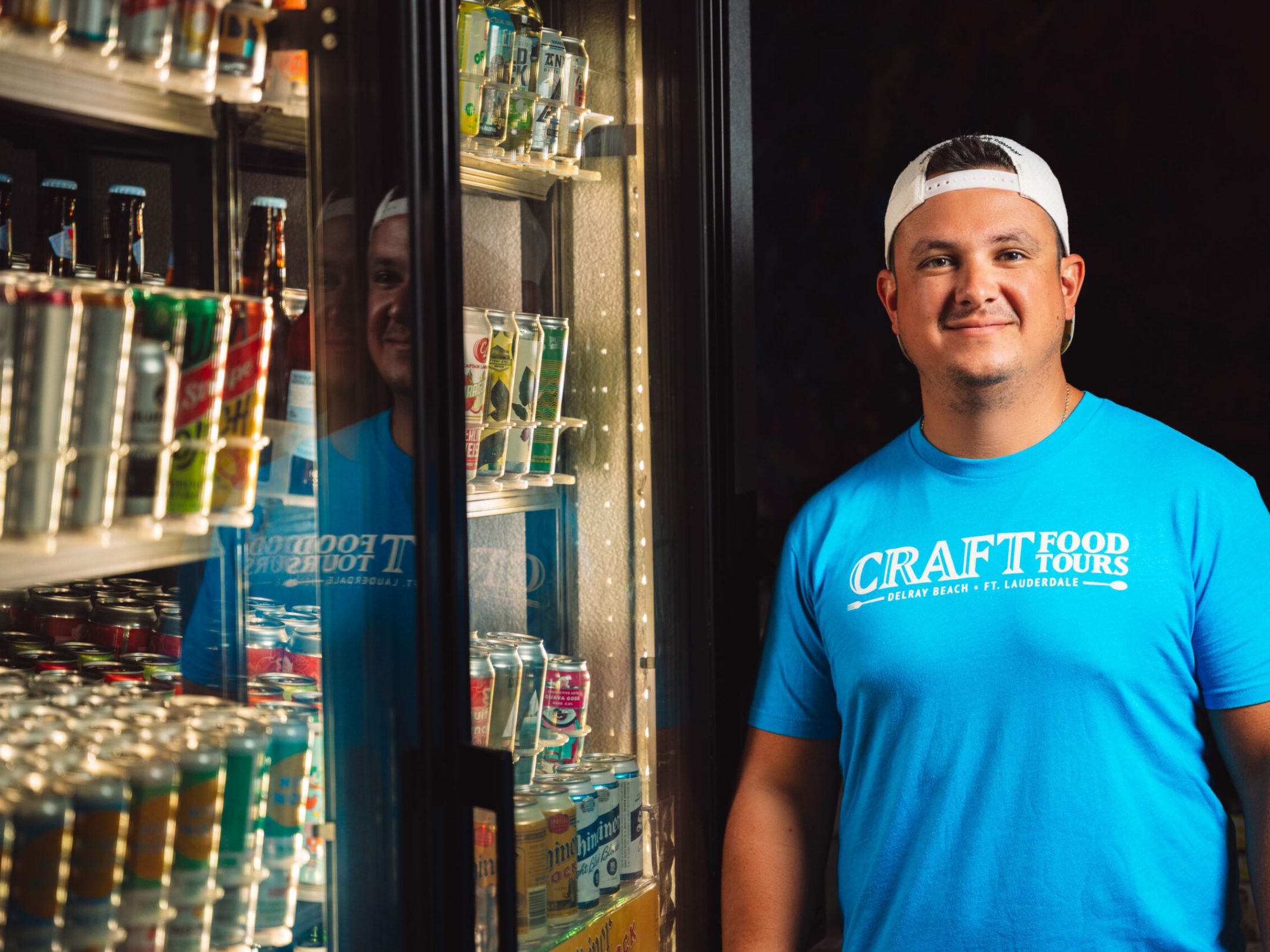 a man in a blue shirt standing in front of a store