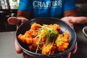 a person holding a bowl of food