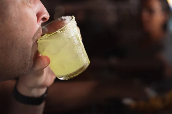 a close up of a man eating a sandwich