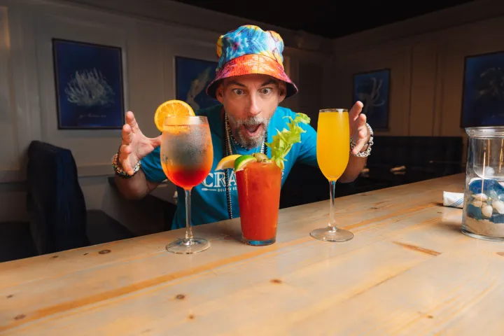 a person sitting at a table with a glass of orange juice